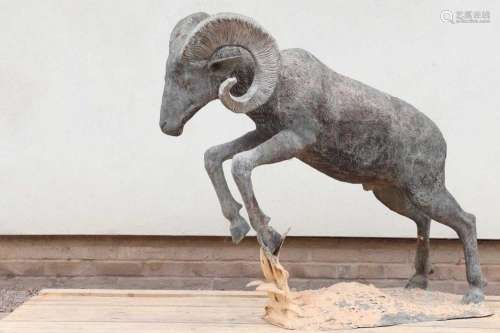 A large bronze figure of a goat,