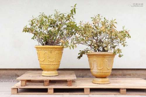 A pair of yellow-glazed earthenware planters