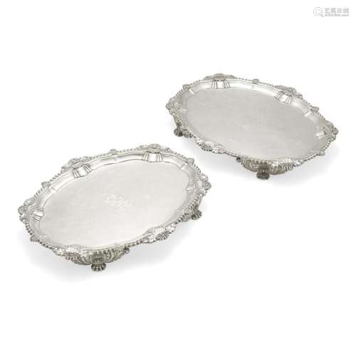 A PAIR OF REGENCY SILVER FOOTED SALVERS by Benjamin Smith II...