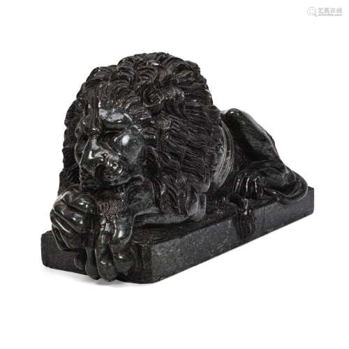 AN ENGLISH CARVED GREEN MARBLE RECUMBENT LIONAfter Antonio C...