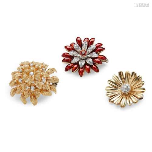 A collection of floral brooches