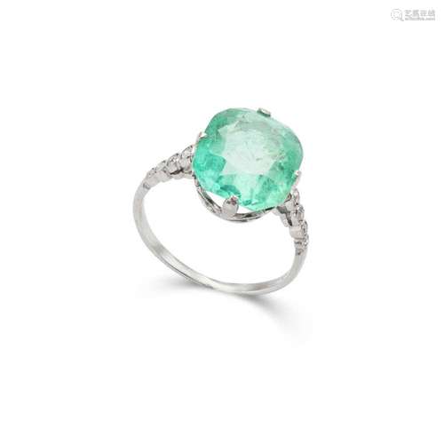 An emerald and diamond ring