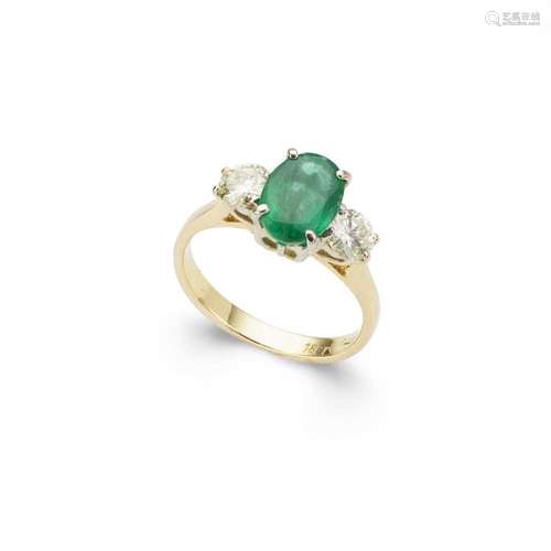 An emerald and diamond three-stone ring