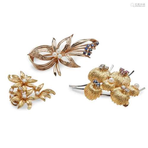 A collection of three floral brooches