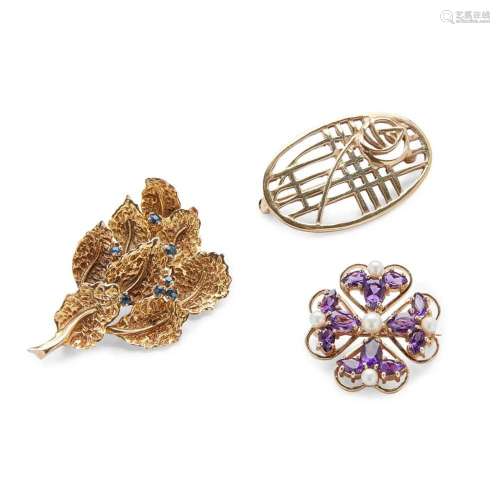 A collection of three brooches