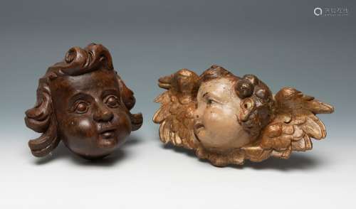 Two heads of angels. 19th century.Carved and polychromed woo...