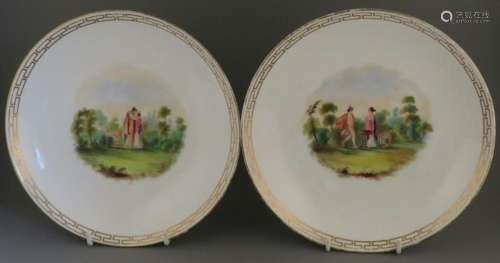 A pair of hand-painted and titled porcelain large saucer dis...