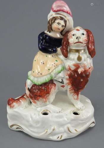 A mid-nineteenth century Staffordshire girl on a spaniel qui...