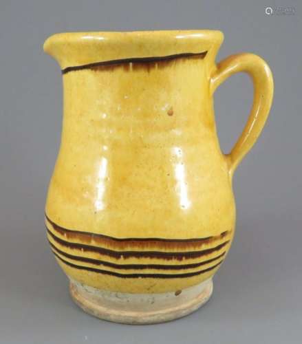 An early nineteenth century yellow glazed slip decorated jug...