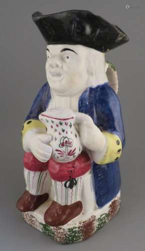 An early nineteenth century pearlware toby jug, c. 1830. It ...