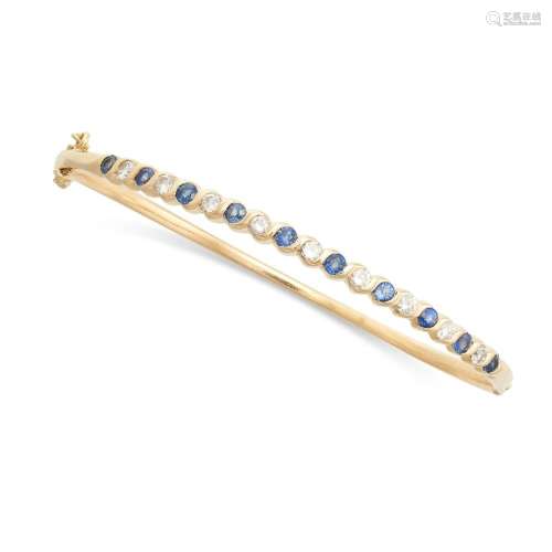 A SAPPHIRE AND DIAMOND BANGLE in 18ct yellow gold, set with ...