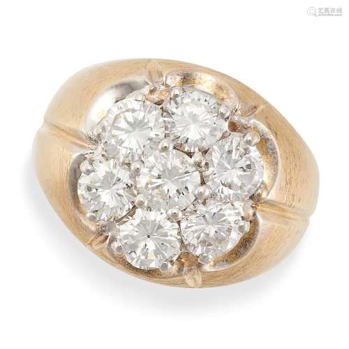 A DIAMOND CLUSTER DRESS RING in yellow gold, set with seven ...