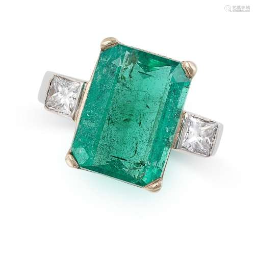 AN EMERALD AND DIAMOND RING set with an octagonal step cut e...