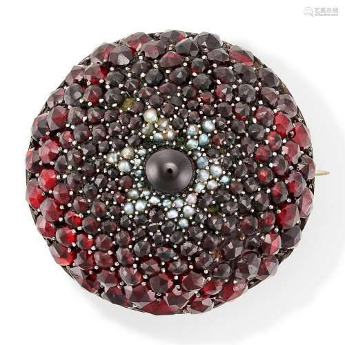 AN ANTIQUE GARNET AND PEARL BROOCH the domed body set to the...