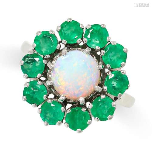 AN OPAL AND EMERALD CLUSTER RING set with a cabochon opal in...