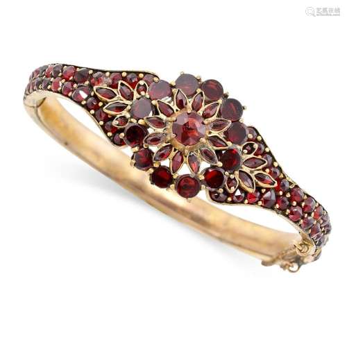 AN ANTIQUE BOHEMIAN GARNET BANGLE set throughout with rose c...