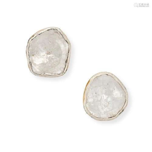 A PAIR OF DIAMOND STUD EARRINGS each set with a flat cut dia...