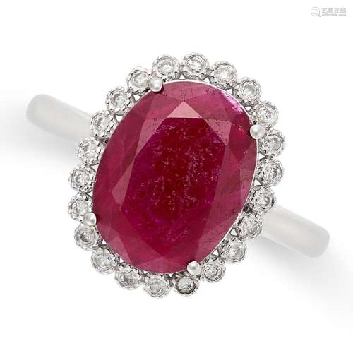 A RUBY AND DIAMOND CLUSTER RING in 18ct white gold, set with...