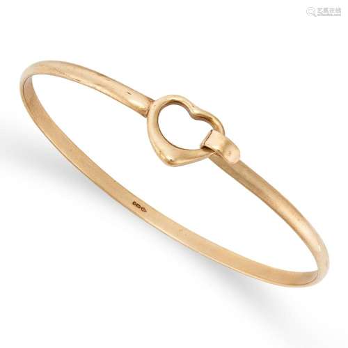 A GOLD BANGLE in 9ct yellow gold, designed with a heart moti...