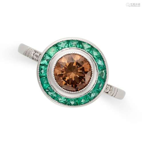 A BROWN DIAMOND AND EMERALD TARGET RING set with a round bri...