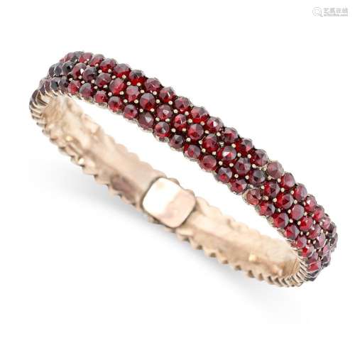 AN ANTIQUE BOHEMIAN GARNET BANGLE set with three rows of ros...