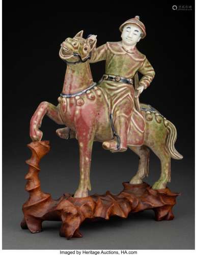 A Chinese Glazed Porcelain Figure of a Horse and Rider, 19th...