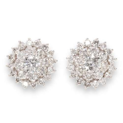 A pair of diamond and fourteen karat white gold earrings