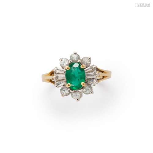 An emerald, white sapphire and fourteen karat gold ring