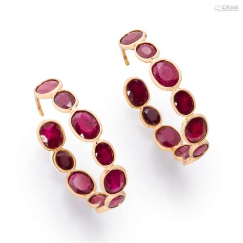 A pair of ruby and eighteen karat gold hoop earrings