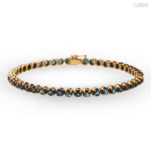 A sapphire and fourteen karat gold bracelet