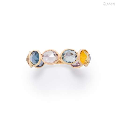 A fancy colored sapphire and eighteen karat gold ring