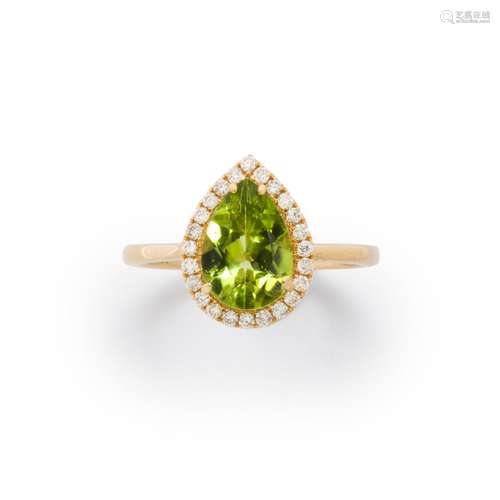 A peridot, diamond and fourteen karat gold ring