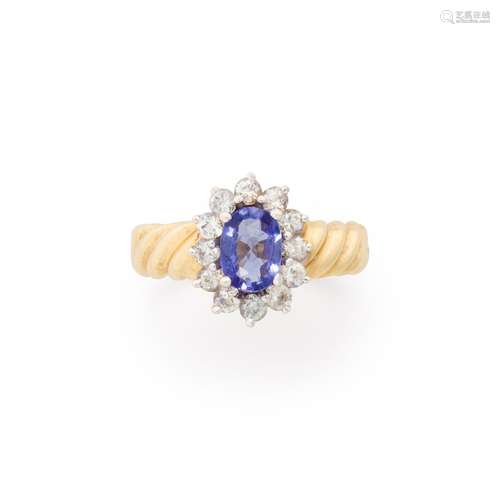 A tanzanite, white sapphire and fourteen karat gold ring