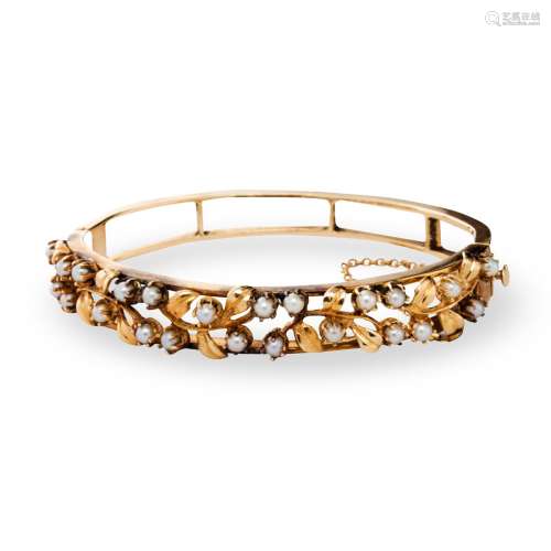 A seed pearl and fourteen karat gold bangle