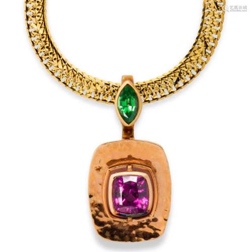 A pink or green garnet and fourteen karat bi-color gold pend...