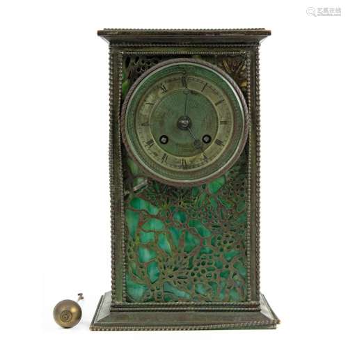 A Riviere patinated metal and slag glass table clock in a gr...
