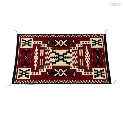 A Navajo Storm pattern rug, 63