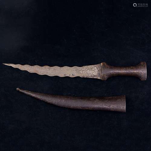 A Persian Qajar sword, the curved blade heavily etched with ...