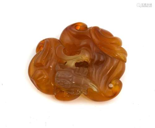 A Chinese Hardstone Carving, as a fruit on an amber-coloured...