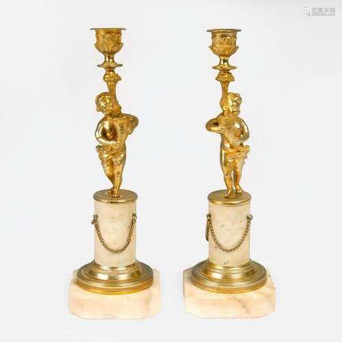 A Pair of Napoleon III Candlesticks with Putti.