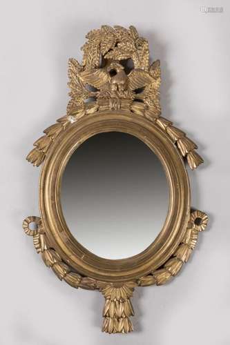 MIROIR en bois redoré de forme ovale à décor de guirlande de...