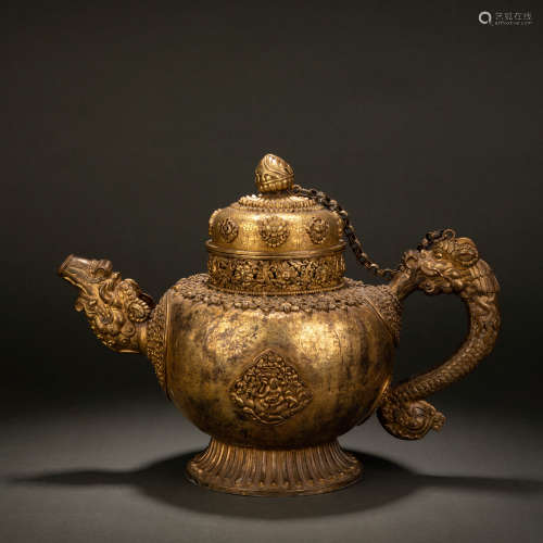 A gilt-silver figure with dragon's head and dragon's hand ho...