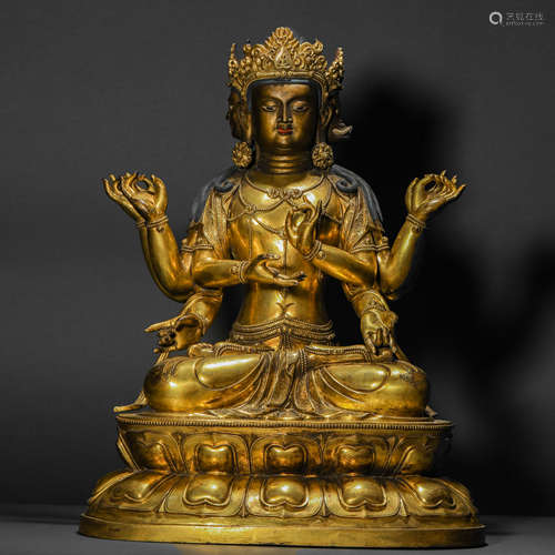 A Gilt Bronze Statue of a Three-Faced Buddha with Eight Arms...