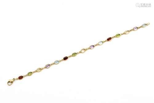 Bracelet souple en or jaune 18 K (750) suite de pierres fine...