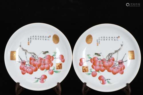 A pair of pastel melon, fruit and insect plates