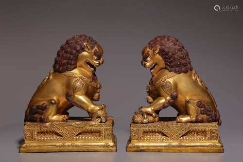 Qing Dynasty, a pair of bronze gilt lion ornaments