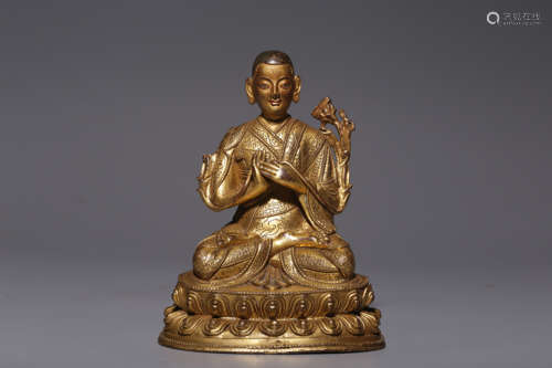 In the Qing Dynasty, a sitting bronze gilt statue of a maste...