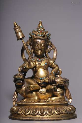 In the Qing Dynasty, a sitting statue of a gold-plated coppe...