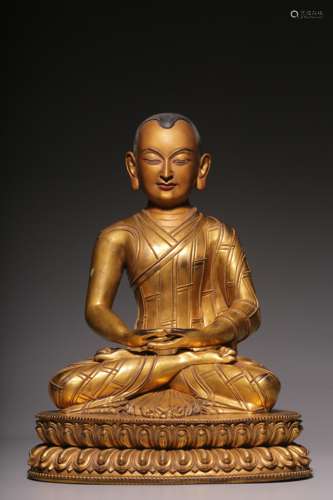 In the Qing Dynasty, a sitting bronze gilt statue of a maste...