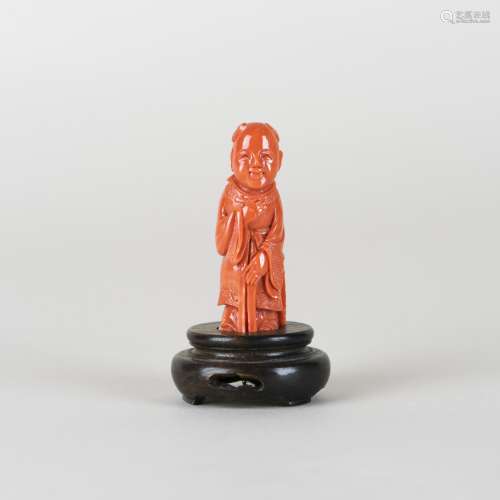 A CARVED CORAL OF FIGURE WITH STAND